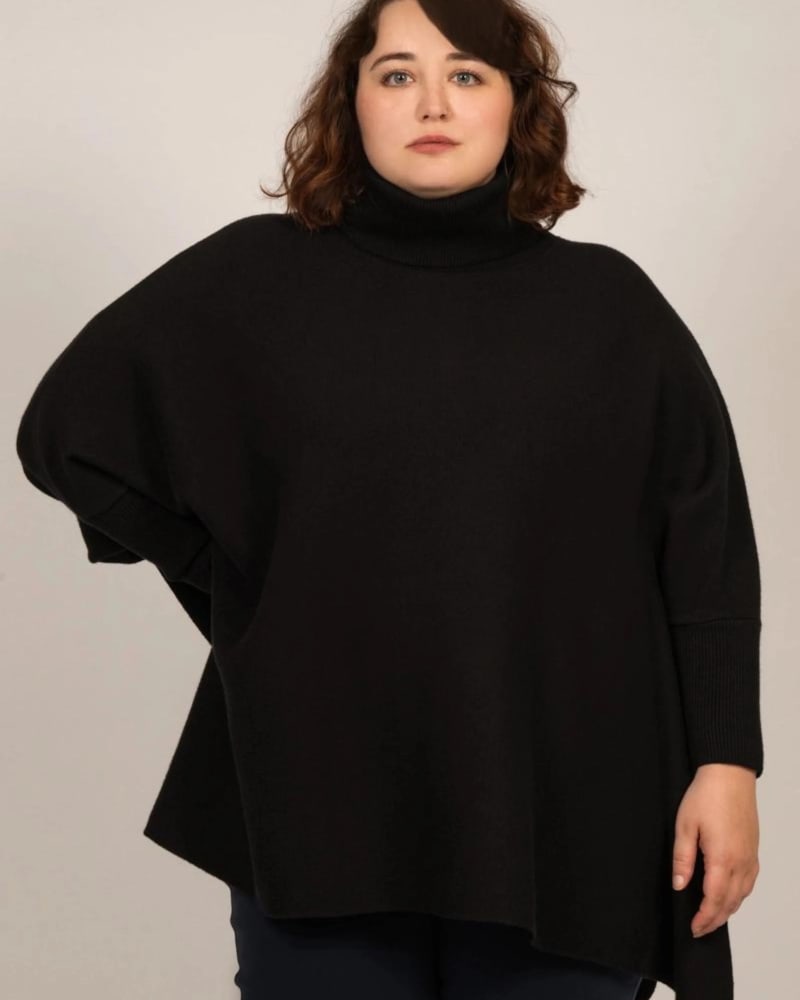 Front of a model wearing a size L/XL Eliana Relaxed Turtleneck Sweater Black in Black by ANNICK. | dia_product_style_image_id:310663
